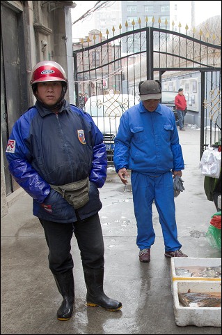 Selling fish in a Shanghai alley.