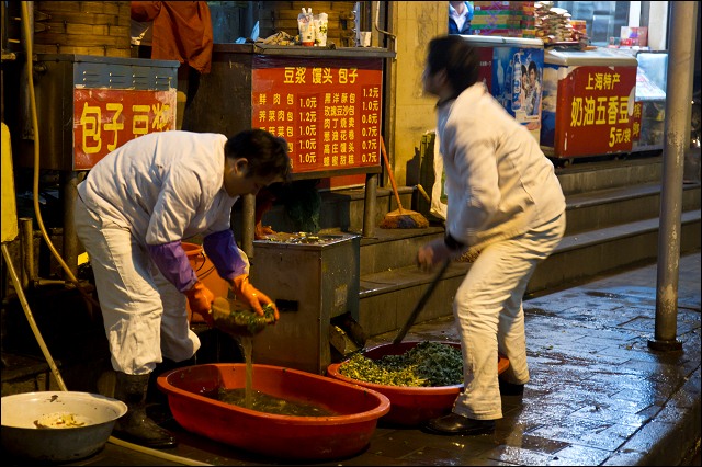 Preparing food on the street, Shanghai, China.