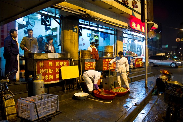 Preparing food on the street, Shanghai, China.