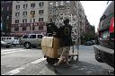 Pushing bar stools on the Bowery. NYC.