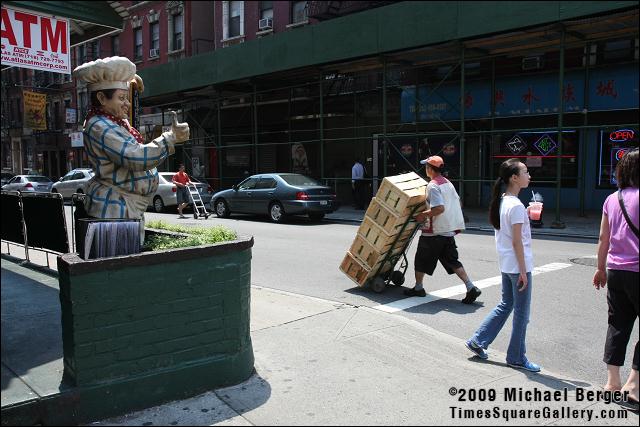 Pushing produce down the street. Little Italy, NYC.