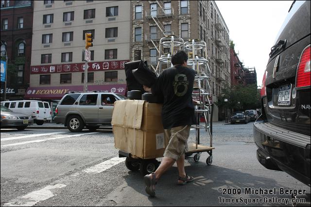 Pushing bar stools on the Bowery. NYC.