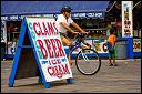 Bicyclist with helmet on the boardwalk, Coney Island, NY.