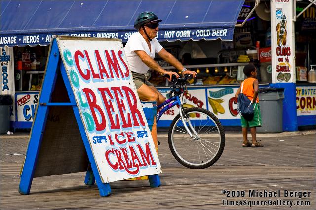 Bicyclist with helmet on the boardwalk, Coney Island, NY.