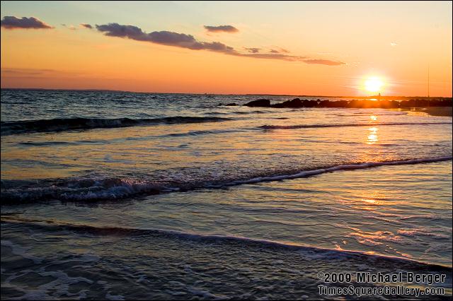 Surf fisherman near the rocks at sunset. Fort Tilden, NY.