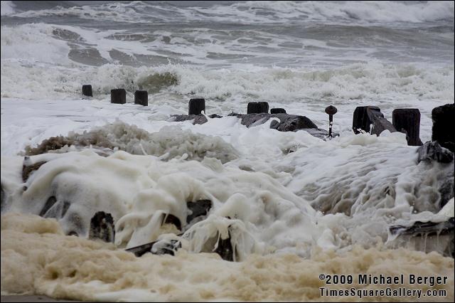 Water powerfully rushes over beach frontduring winter storm.  Fort Tilden, NY.