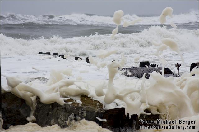 Water powerfully rushes over beach frontduring winter storm.  Fort Tilden, NY.