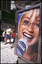 Poster on the side of telephone kiosk in Times Square. 2002.