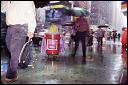 Cleaning the streets during a heavy summer rain on 7th Ave. in Times Square. 2002.