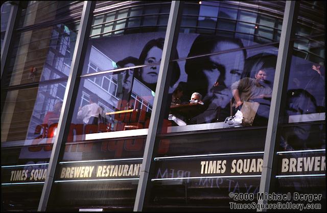 An ad forThe Sopranos television show reflected in the windows of a restaurant on W. 42nd Street between Broadway and 7th Avenue, 2000.