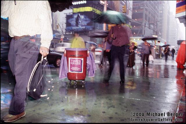 Cleaning the streets during a heavy summer rain on 7th Ave. in Times Square. 2002.