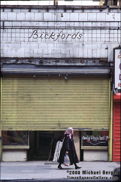Woman with groceries passing old Bickford's cafeteria on West 42nd Street. 1997.