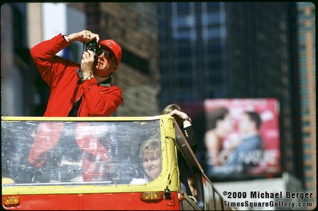 Photographing the sights above in Times Square from a moving tour bus. 1999.