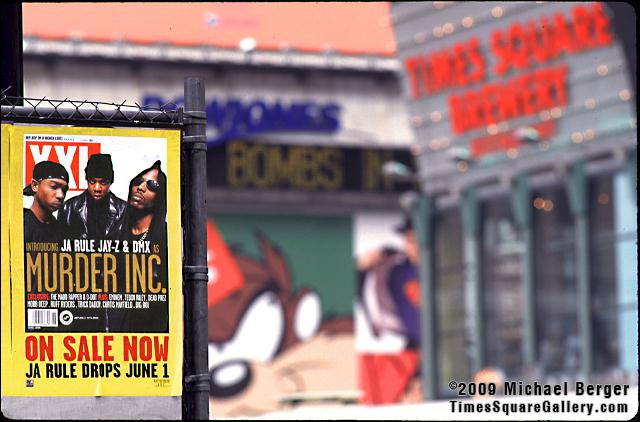 Poster on parking lot fence on West 41st Street off 7th Avenue with 1 Times Square zipper. 1999.